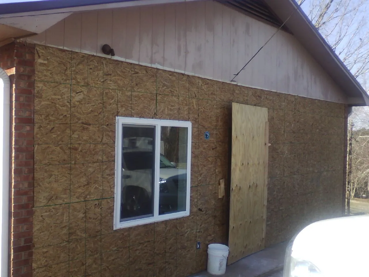 OSB sheathing on a garage addition wall before siding in Effingham